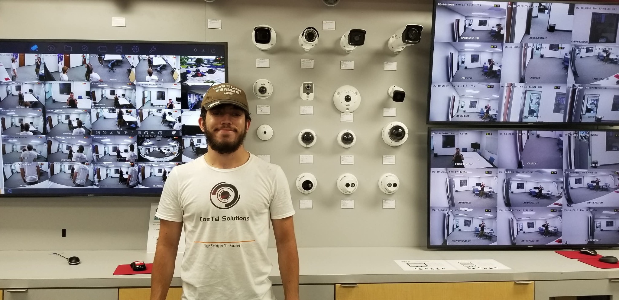 Comtel Solutions company photo with security cameras and surveillance displays